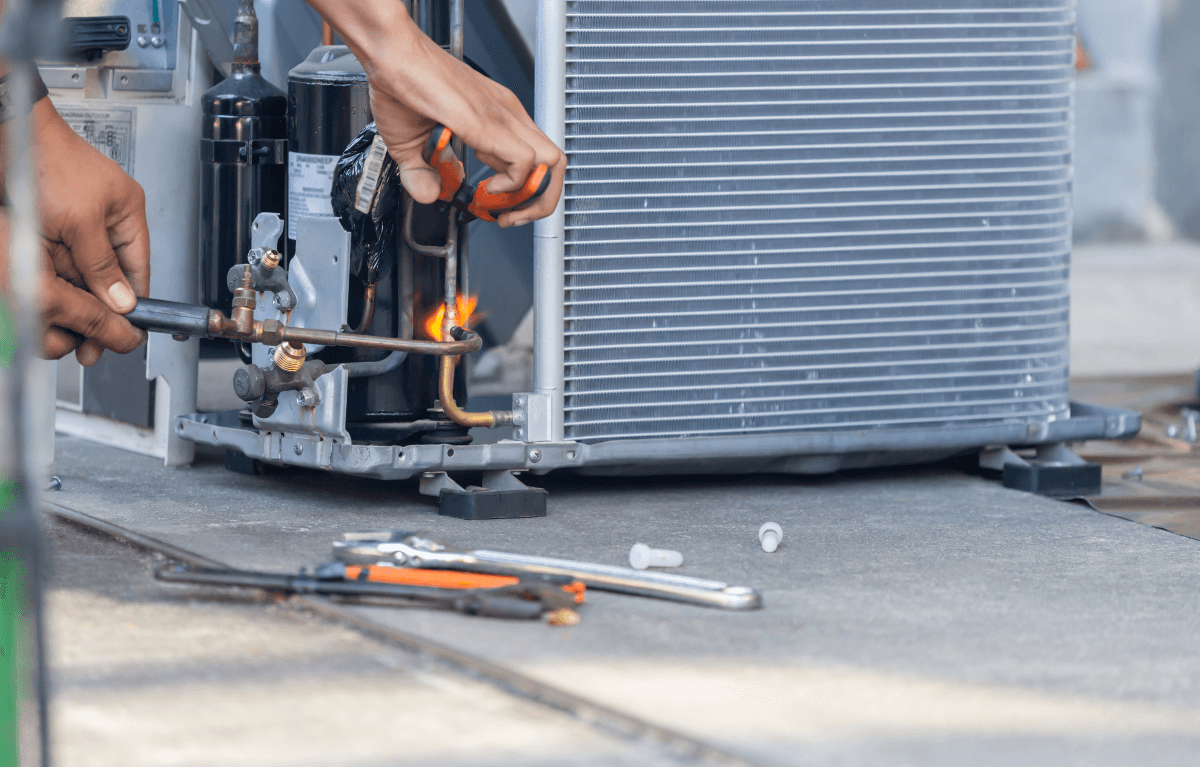 Air conditioning repair man welding gas lines