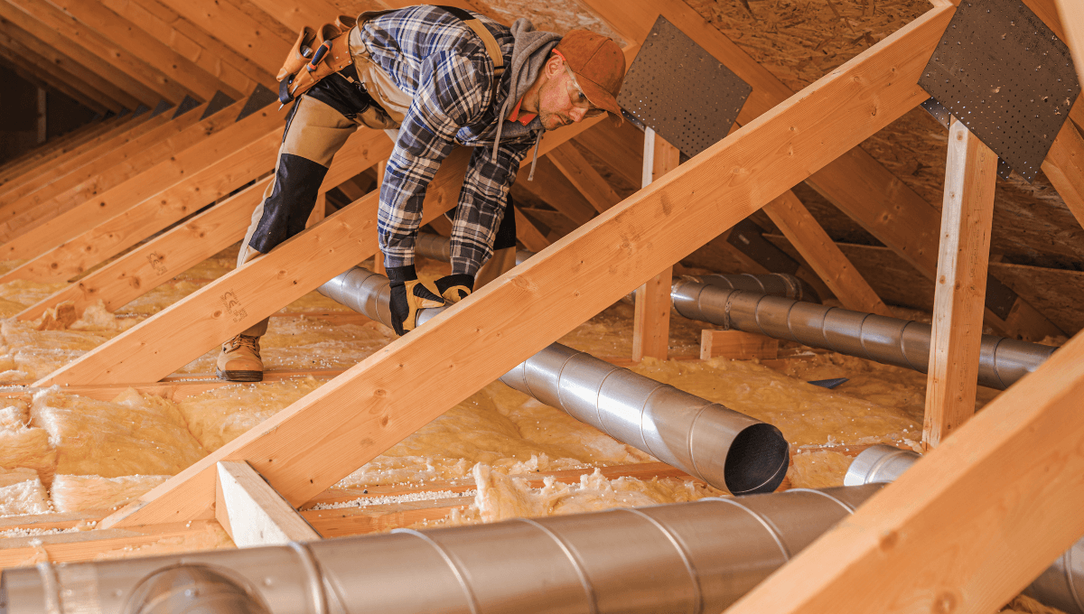 HVAC tech installing new ductwork in home