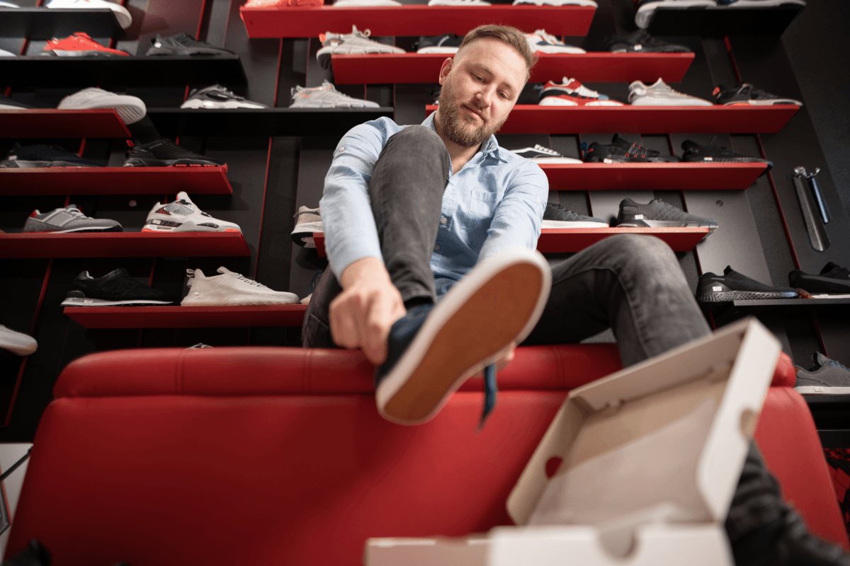Man trying on new sneakers after payday
