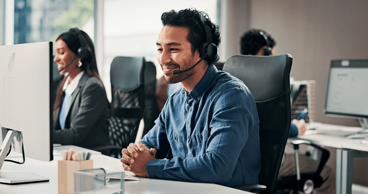Banking customer service representative at a desk with headset, Eight in ten respondents (81%) consider human customer support very or extremely important, with its importance increasing among younger generations.