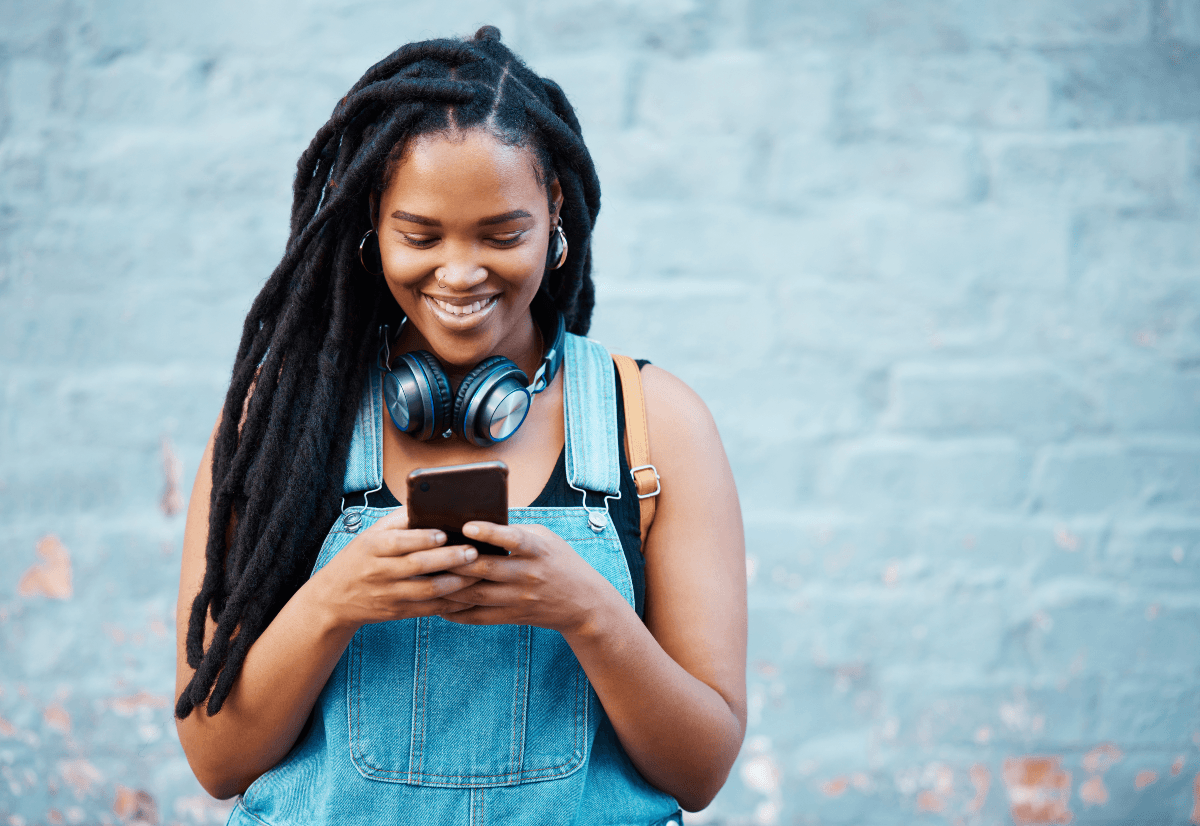 Gen Z woman on cell phone, showing that Gen Z leads digital banking use at 97%, while 91% consider mobile app quality very or extremely important.