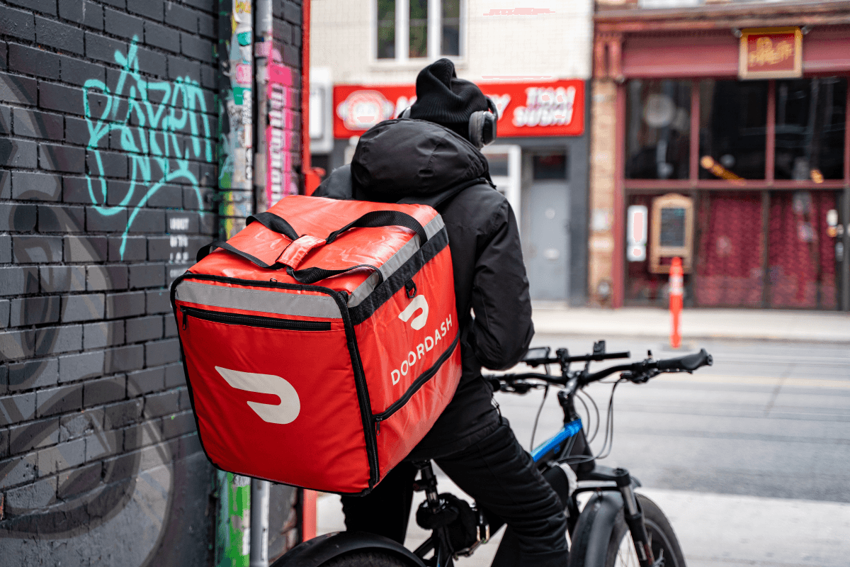 Door Dash delivery guy on bike on street