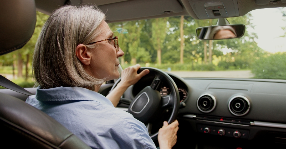 elderly woman driving her car