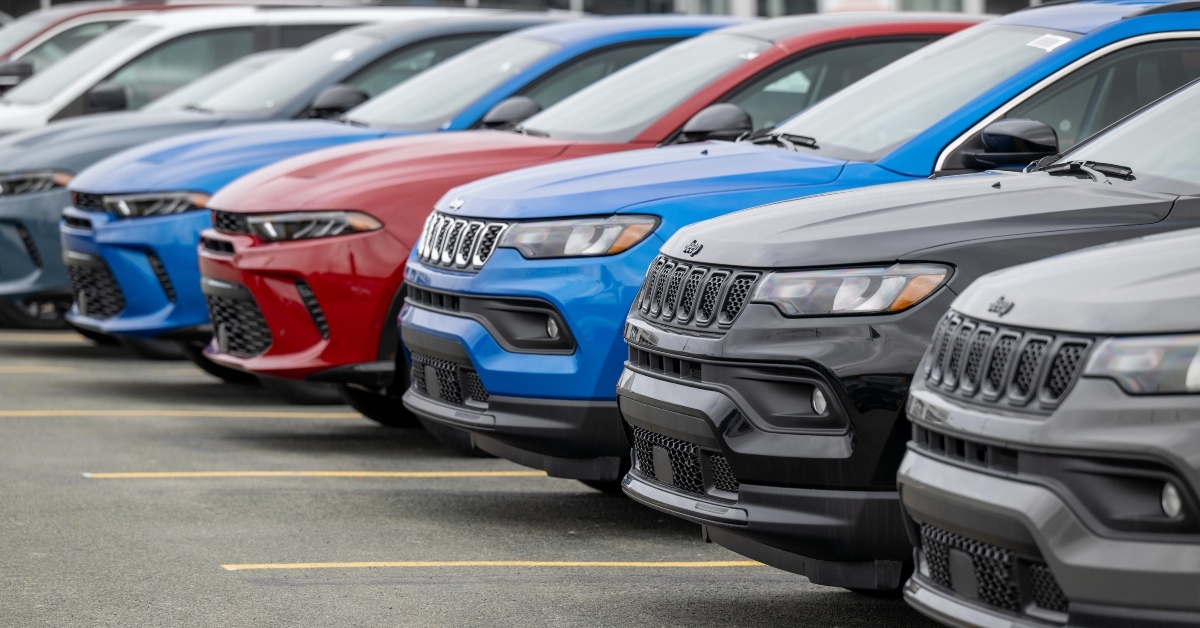 a row of new cars in the parking lot