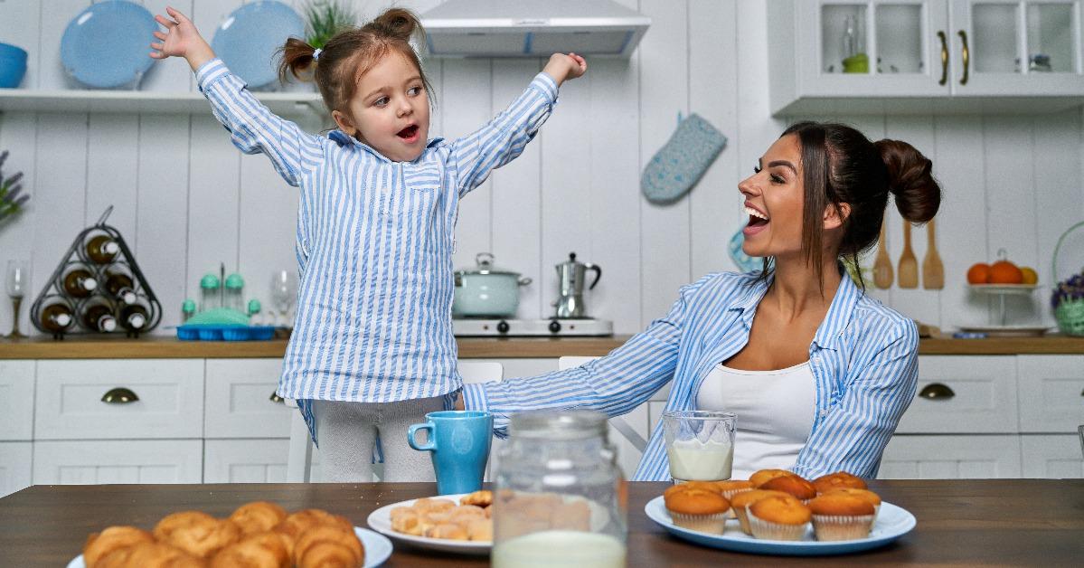 mother and her little daughter playing in the kitchen