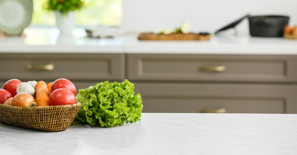 basket with vegetables on table in modern kitchen