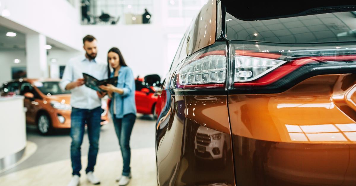 couple buying a new car in dealership