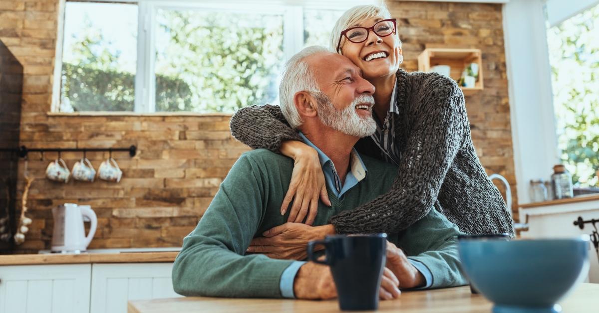 senior couple hugging in the kitchen