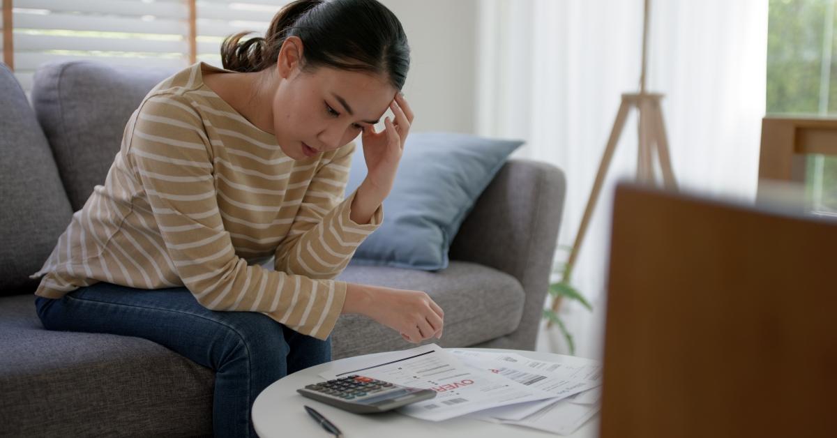 tired young lady upset about unpaid bills