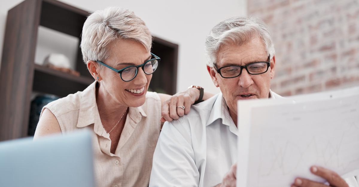 senior couple holding an invoice