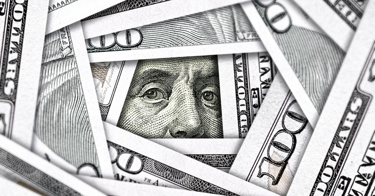 eyes watching from stack of money