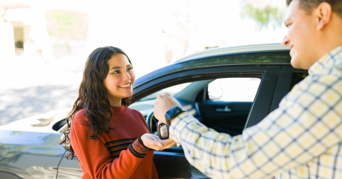 father handing car keys
