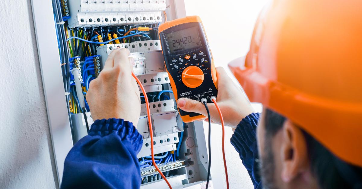 Electrician installing electric cable wires