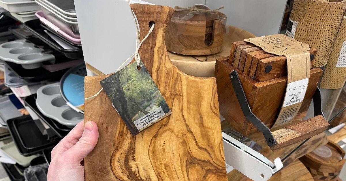 person holding a wooden cutting board