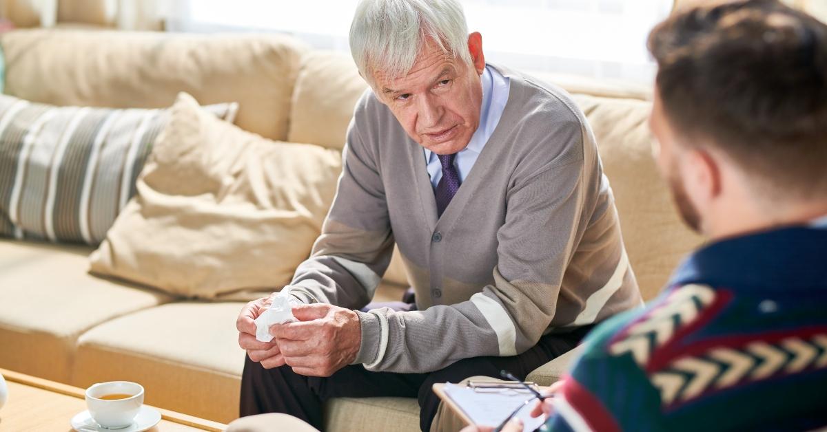man holding tissues sharing mental problems