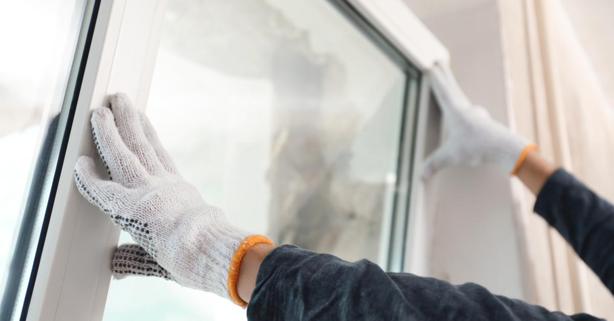worker installing plastic window
