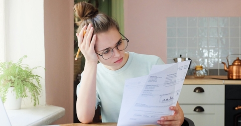 Woman looking confused at documents