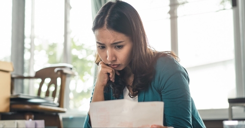 Worried woman looking at paperwork