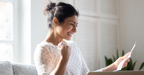 Happy woman looking at paperwork