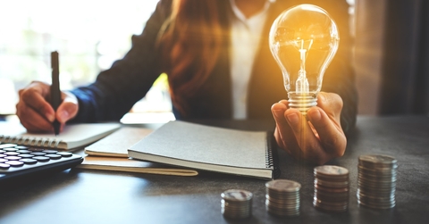 Woman holding light bulb
