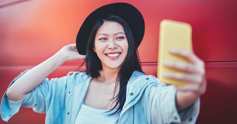Happy woman taking selfie