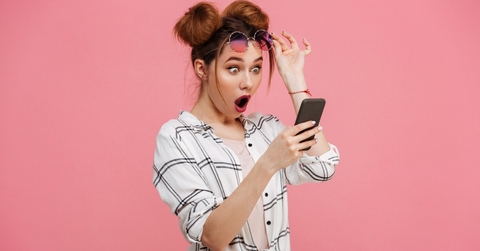 woman looking surprised at phone