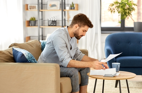 Worried man reviewing budget