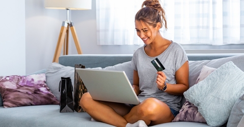 Woman using laptop and credit card