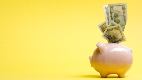 Piggy bank isolated on yellow background.