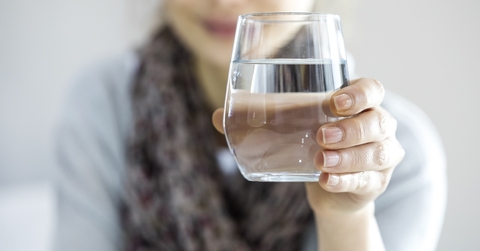 Woman holding a glass of water