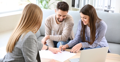 Couple signing loan paperwork