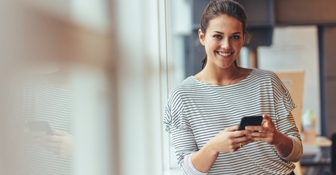 Happy woman using her phone