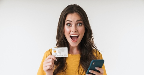 Happy woman holding credit card