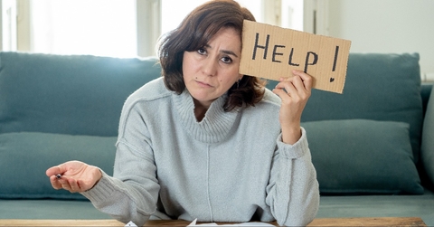 upset young woman asking for help in paying bills