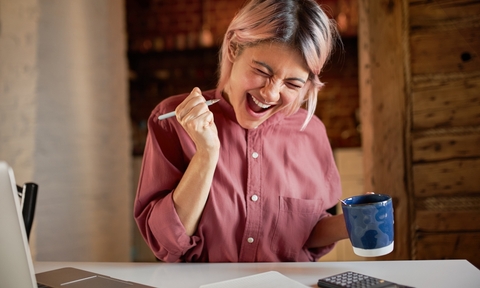 woman who is happy about figuring out her finances