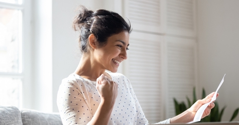 Happy woman reading letter