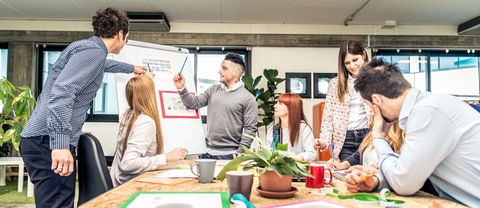 group of people in a room discussing a plan
