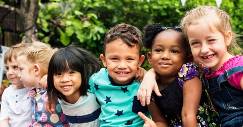 group of kindergartener with their friends smiling