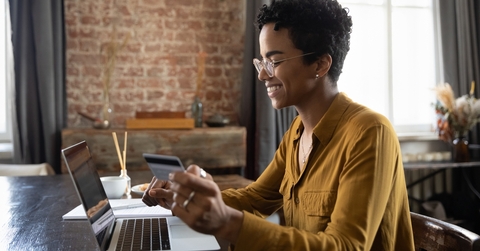 Woman with credit card looking at computer