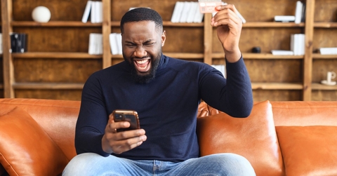 Adult man using phone apps to earn gift cards
