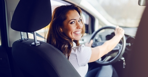 Woman in driver&#x27;s seat smiling
