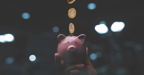 Money going into a piggy bank