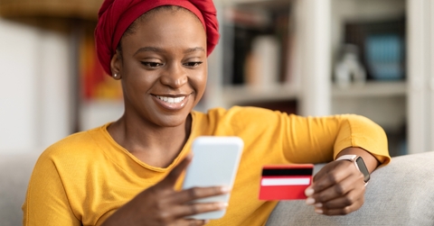 An adult woman using a credit card