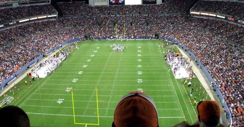 spectators watching football game in stadium