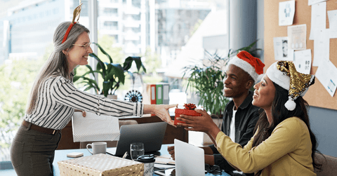 People getting holiday gifts from a boss at the office