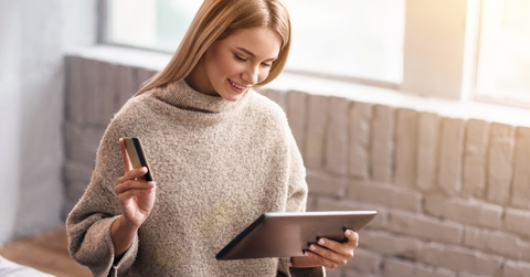 A woman shopping online with a credit card