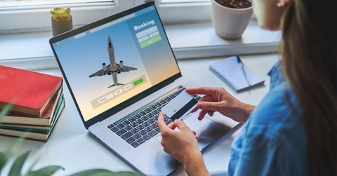 A woman is booking a flight with a credit card
