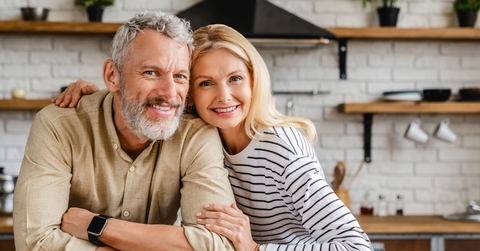 Middle-aged couple smiling at the camera