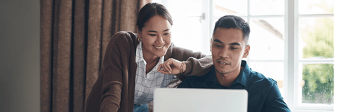 couple working on budget on their laptop