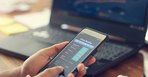 Businessman using online banking services on smartphone